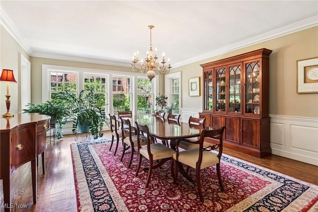 2820 W Park Blvd, Shaker Heights, OH 44120 - dining room featuring ornamental molding, a chandelier, dark wood finished floors, a wainscoted wall, and a decorative wall