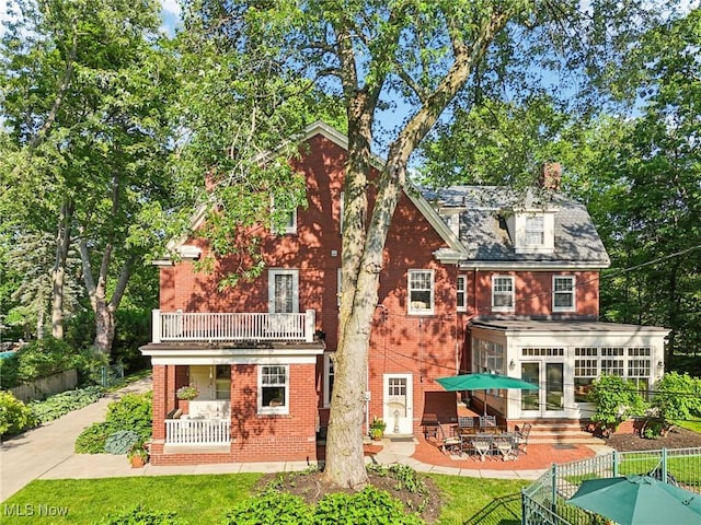 2820 W Park Blvd, Shaker Heights, OH 44120 - rear view of property featuring a balcony, brick siding, a chimney, and a patio