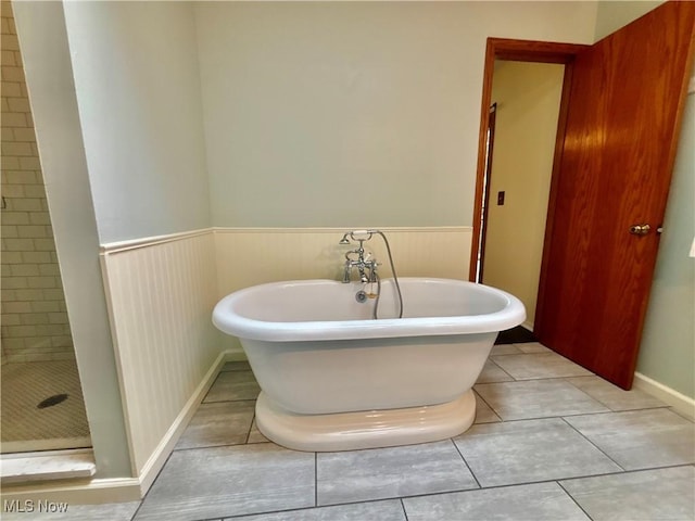 29123 Ridge Rd, Wickliffe, OH 44092 - bathroom with a soaking tub, a stall shower, a wainscoted wall, and tile patterned floors