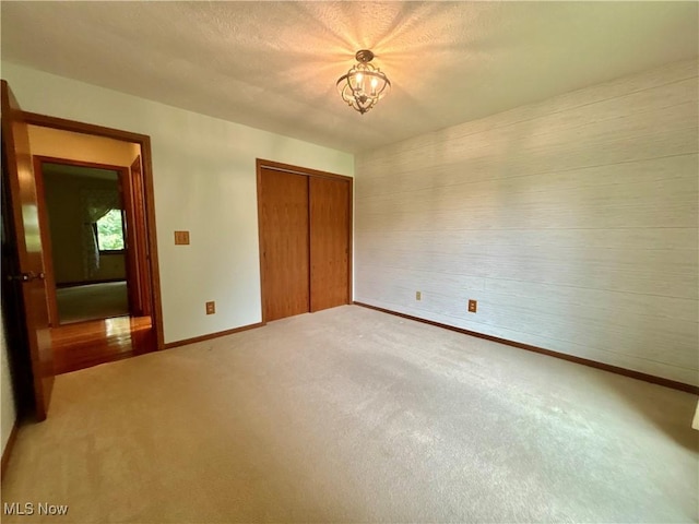 29123 Ridge Rd, Wickliffe, OH 44092 - unfurnished bedroom featuring light colored carpet, a closet, and a chandelier