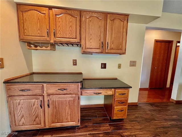 29123 Ridge Rd, Wickliffe, OH 44092 - kitchen with dark countertops, dark wood finished floors, and brown cabinetry