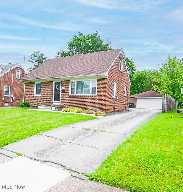 1153 Meadowbrook Ave SE, Warren, OH 44484 - view of front of home with brick siding, a detached garage, an outbuilding, a front lawn, and roof with shingles