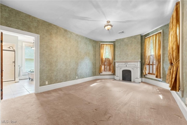 400 E Carrollton St, Magnolia, OH 44643 - unfurnished living room with carpet, a fireplace with flush hearth, and tile patterned floors