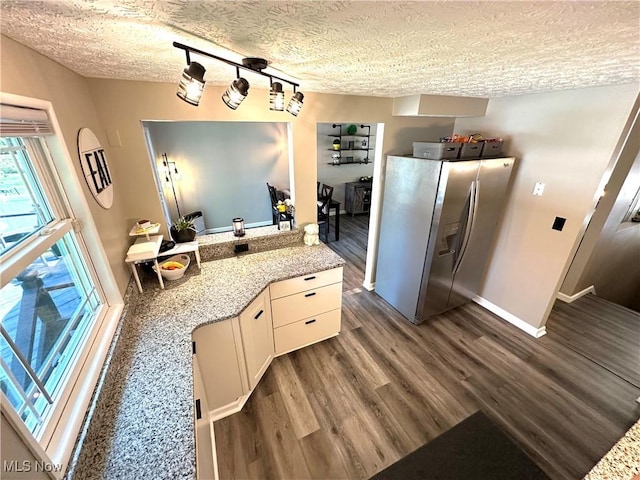 132 Dennis Dr, Cortland, OH 44410 - kitchen featuring stainless steel fridge with ice dispenser, a textured ceiling, dark wood-type flooring, light stone countertops, and white cabinets