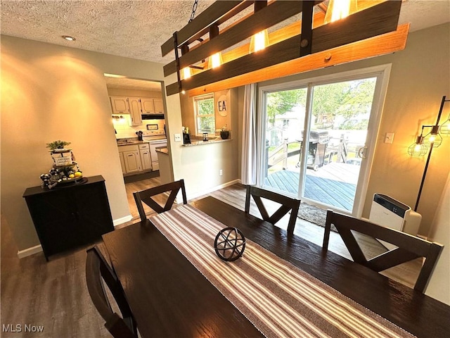 132 Dennis Dr, Cortland, OH 44410 - dining space featuring dark wood-type flooring and a textured ceiling