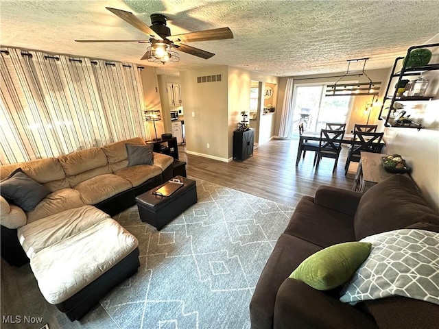 132 Dennis Dr, Cortland, OH 44410 - living room featuring wood finished floors, ceiling fan, and a textured ceiling