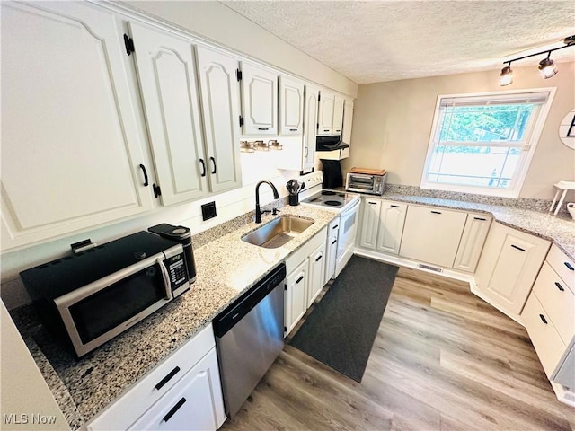 132 Dennis Dr, Cortland, OH 44410 - kitchen featuring electric stove, stainless steel dishwasher, a textured ceiling, white cabinets, and light wood-type flooring