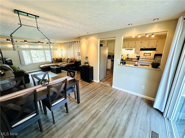 132 Dennis Dr, Cortland, OH 44410 - dining area with a textured ceiling and wood finished floors