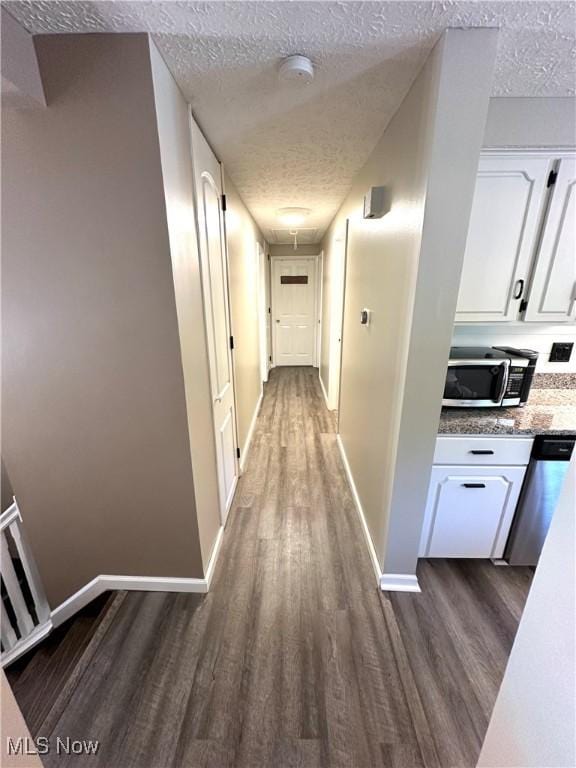 132 Dennis Dr, Cortland, OH 44410 - hallway featuring a textured ceiling and dark wood finished floors