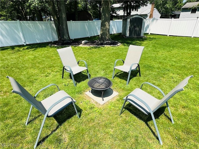 132 Dennis Dr, Cortland, OH 44410 - fenced backyard with a storage shed and a fire pit