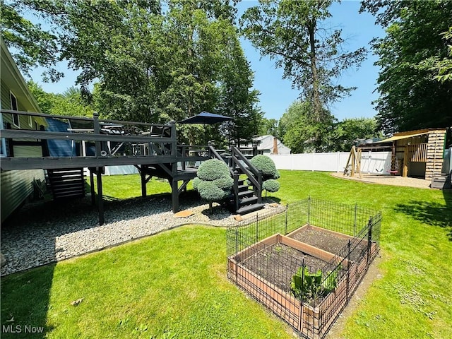 132 Dennis Dr, Cortland, OH 44410 - fenced backyard featuring a vegetable garden, stairs, and a deck