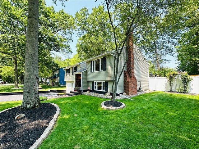 132 Dennis Dr, Cortland, OH 44410 - raised ranch featuring a chimney and a garage