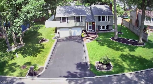 132 Dennis Dr, Cortland, OH 44410 - view of front facade featuring asphalt driveway and a garage