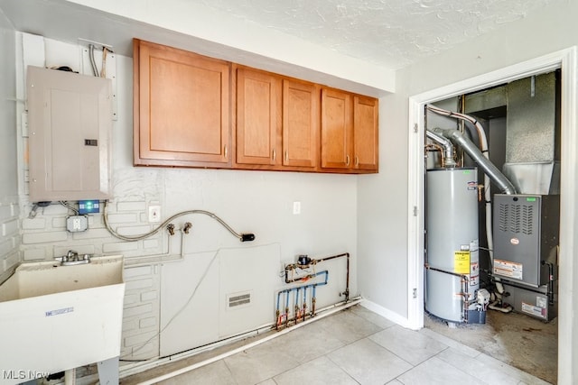 640 E 261st St, Euclid, OH 44132 - laundry area featuring cabinet space, electric panel, gas water heater, a textured ceiling, and light tile patterned flooring