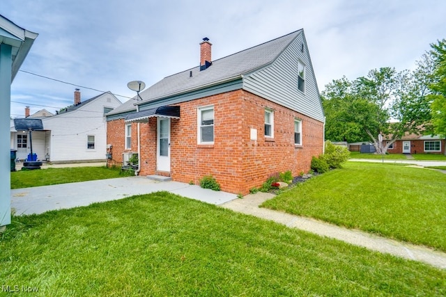 640 E 261st St, Euclid, OH 44132 - view of front facade featuring brick siding, a front yard, and a chimney