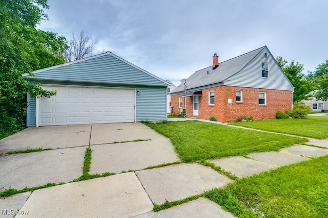 640 E 261st St, Euclid, OH 44132 - view of front of property featuring a front yard, brick siding, and a garage