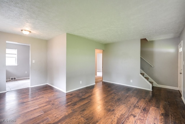 640 E 261st St, Euclid, OH 44132 - empty room with a textured ceiling, wood finished floors, and stairs