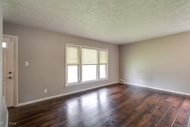 640 E 261st St, Euclid, OH 44132 - unfurnished room with dark wood finished floors and a textured ceiling