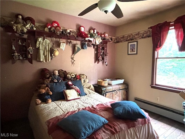 38474 Longs Crossing Rd, Leetonia, OH 44431 - bedroom with a baseboard heating unit, ceiling fan, and wood finished floors