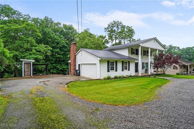 7436 Crory Rd, Canfield, OH 44406 - neoclassical home with driveway, a chimney, an attached garage, a metal roof, and a front yard