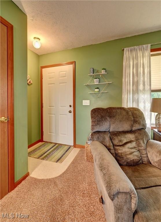 5075 State Route 250 NW, Beach City, OH 44608 - carpeted living room with baseboards and a textured ceiling