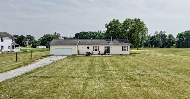5075 State Route 250 NW, Beach City, OH 44608 - view of front of house featuring gravel driveway, a garage, a front lawn, a patio, and view of wooded area