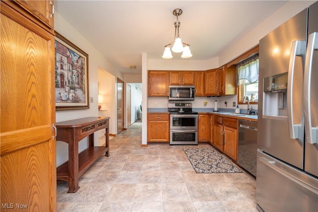3661 Meander Reserve Cir, Canfield, OH 44406 - kitchen featuring appliances with stainless steel finishes, brown cabinets, pendant lighting, and light countertops