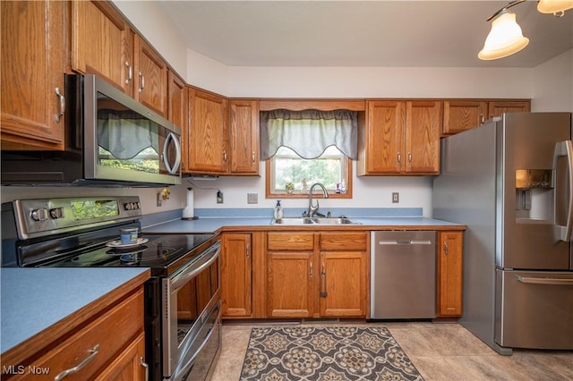 3661 Meander Reserve Cir, Canfield, OH 44406 - kitchen with appliances with stainless steel finishes, brown cabinets, light tile patterned floors, and light countertops