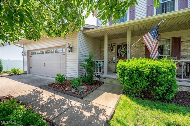 3661 Meander Reserve Cir, Canfield, OH 44406 - entrance to property with covered porch, driveway, brick siding, and an attached garage
