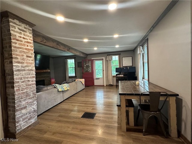 5130 Winfield St NE, East Canton, OH 44730 - living room featuring wood finished floors, a brick fireplace, and recessed lighting