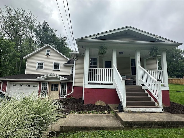 5130 Winfield St NE, East Canton, OH 44730 - view of front facade featuring a porch and an attached garage