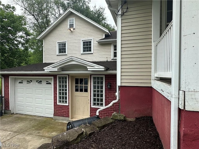 5130 Winfield St NE, East Canton, OH 44730 - view of front of house featuring brick siding, driveway, an attached garage, and roof with shingles