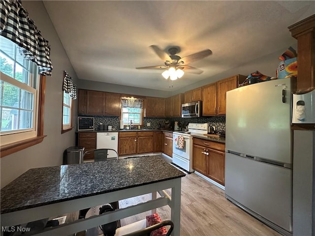 5130 Winfield St NE, East Canton, OH 44730 - kitchen featuring white appliances, decorative backsplash, a ceiling fan, and light wood finished floors