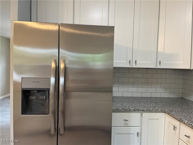 5482 Pleasant St, North Ridgeville, OH 44039 - kitchen with stainless steel fridge, white cabinetry, backsplash, and stone countertops