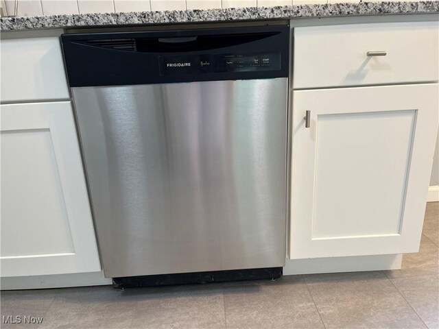 5482 Pleasant St, North Ridgeville, OH 44039 - kitchen view of stainless steel dishwasher, white cabinetry, and light countertops