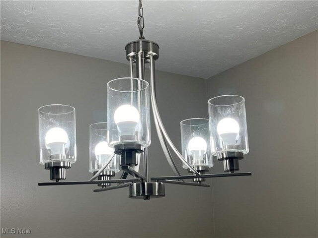 5482 Pleasant St, North Ridgeville, OH 44039 - detailed view of a chandelier and a textured ceiling
