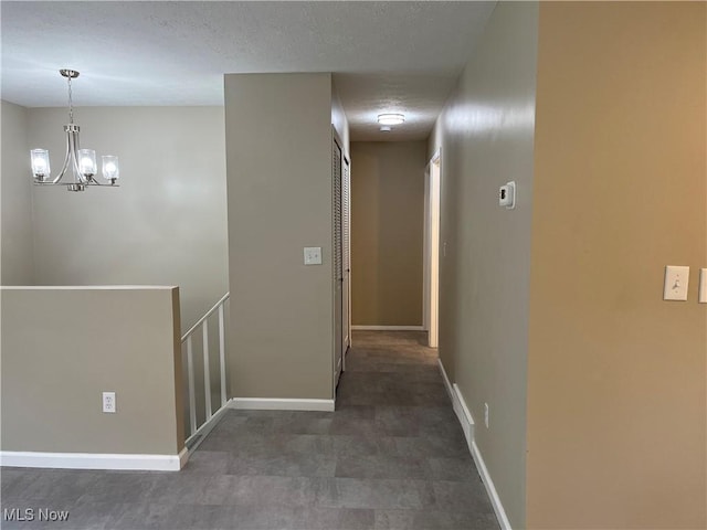 5482 Pleasant St, North Ridgeville, OH 44039 - hall with an upstairs landing, a chandelier, and a textured ceiling