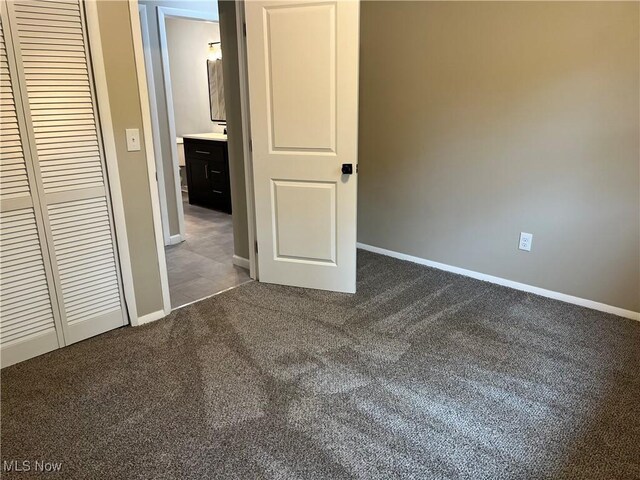 5482 Pleasant St, North Ridgeville, OH 44039 - unfurnished bedroom with dark carpet and a closet