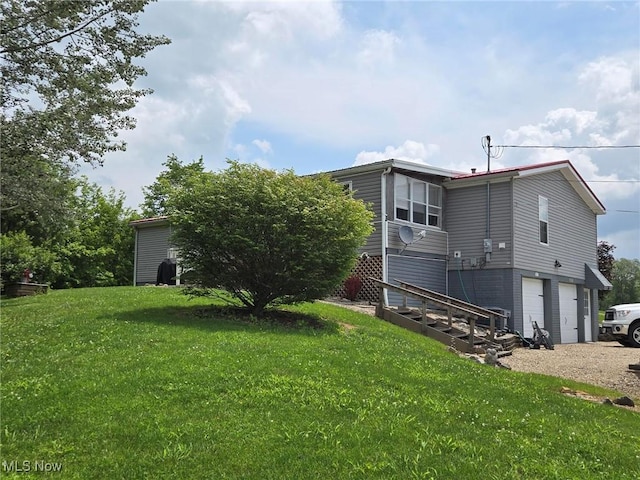 1947 N Vinegar Hill Rd NE, Mcconnelsville, OH 43756 - rear view of house featuring a garage, driveway, and a lawn