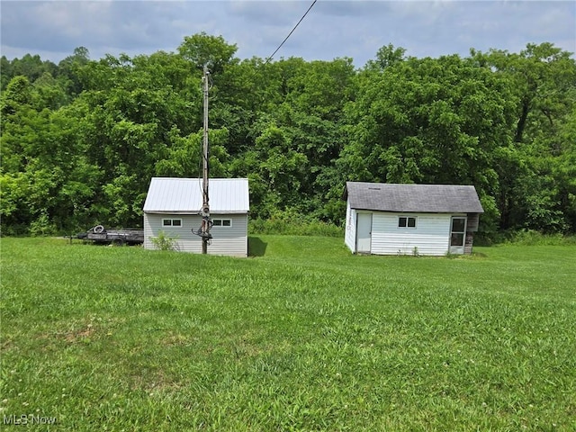 1947 N Vinegar Hill Rd NE, Mcconnelsville, OH 43756 - view of green lawn with an outbuilding and a forest view