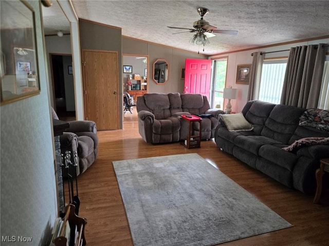 1947 N Vinegar Hill Rd NE, Mcconnelsville, OH 43756 - living room featuring a ceiling fan, vaulted ceiling, ornamental molding, wood finished floors, and a textured ceiling
