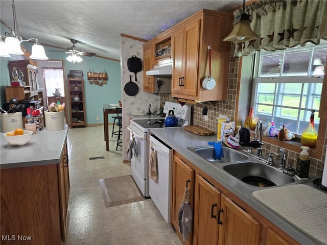1947 N Vinegar Hill Rd NE, Mcconnelsville, OH 43756 - kitchen with under cabinet range hood, white appliances, a ceiling fan, decorative backsplash, and brown cabinetry