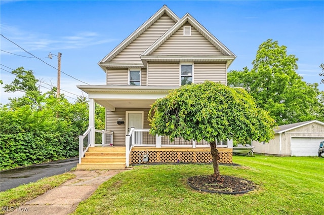 1115 W 43rd St, Ashtabula, OH 44004 - view of front facade featuring a porch, a front lawn, and an outbuilding