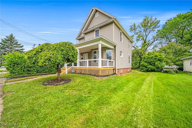 1115 W 43rd St, Ashtabula, OH 44004 - view of front of home with covered porch and a front yard