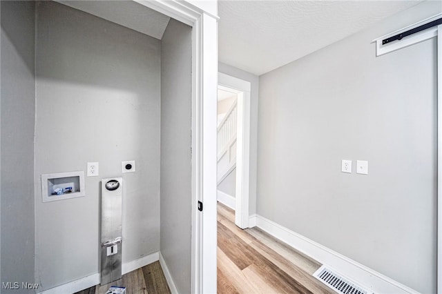 1115 W 43rd St, Ashtabula, OH 44004 - washroom with hookup for an electric dryer, washer hookup, and wood finished floors