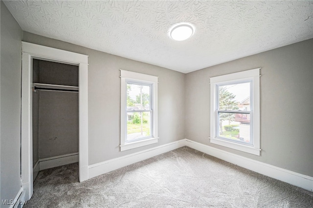 1115 W 43rd St, Ashtabula, OH 44004 - unfurnished bedroom featuring carpet, a textured ceiling, and a closet