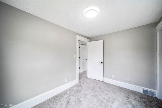 1115 W 43rd St, Ashtabula, OH 44004 - carpeted spare room featuring baseboards and a textured ceiling
