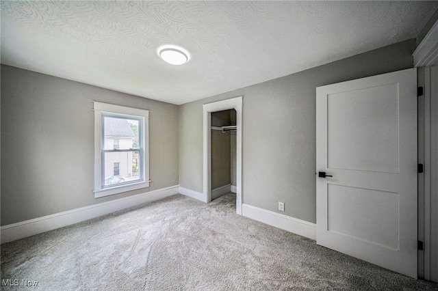 1115 W 43rd St, Ashtabula, OH 44004 - unfurnished bedroom with carpet, a closet, and a textured ceiling