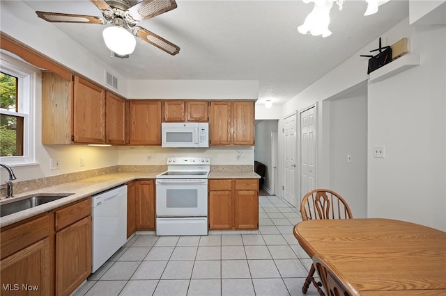 5802 Redwood Ct, Mentor-On-The-Lake, OH 44060 - kitchen featuring white appliances, light countertops, light tile patterned floors, and brown cabinets