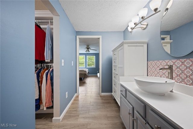 5802 Redwood Ct, Mentor-On-The-Lake, OH 44060 - bathroom featuring a textured ceiling, vanity, ceiling fan, and wood finished floors